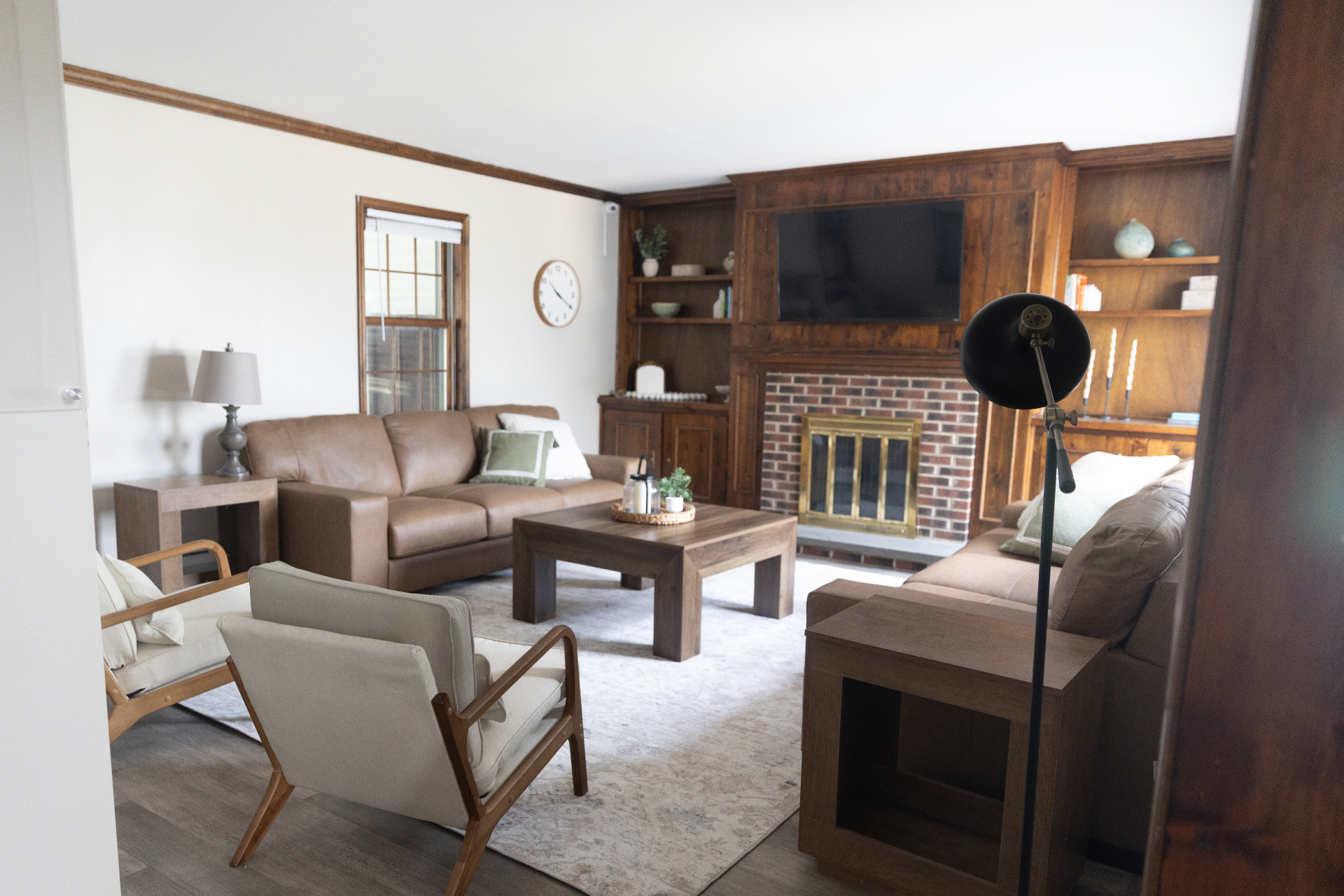Living room with leather couches and brick fireplace