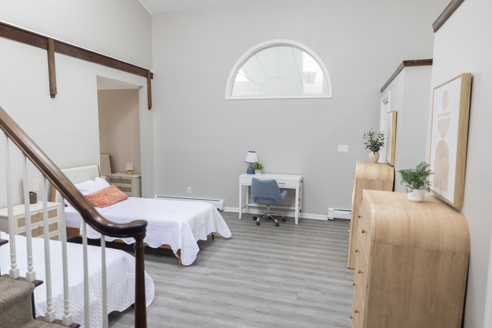 Bedroom loft area with white desk and twin bed