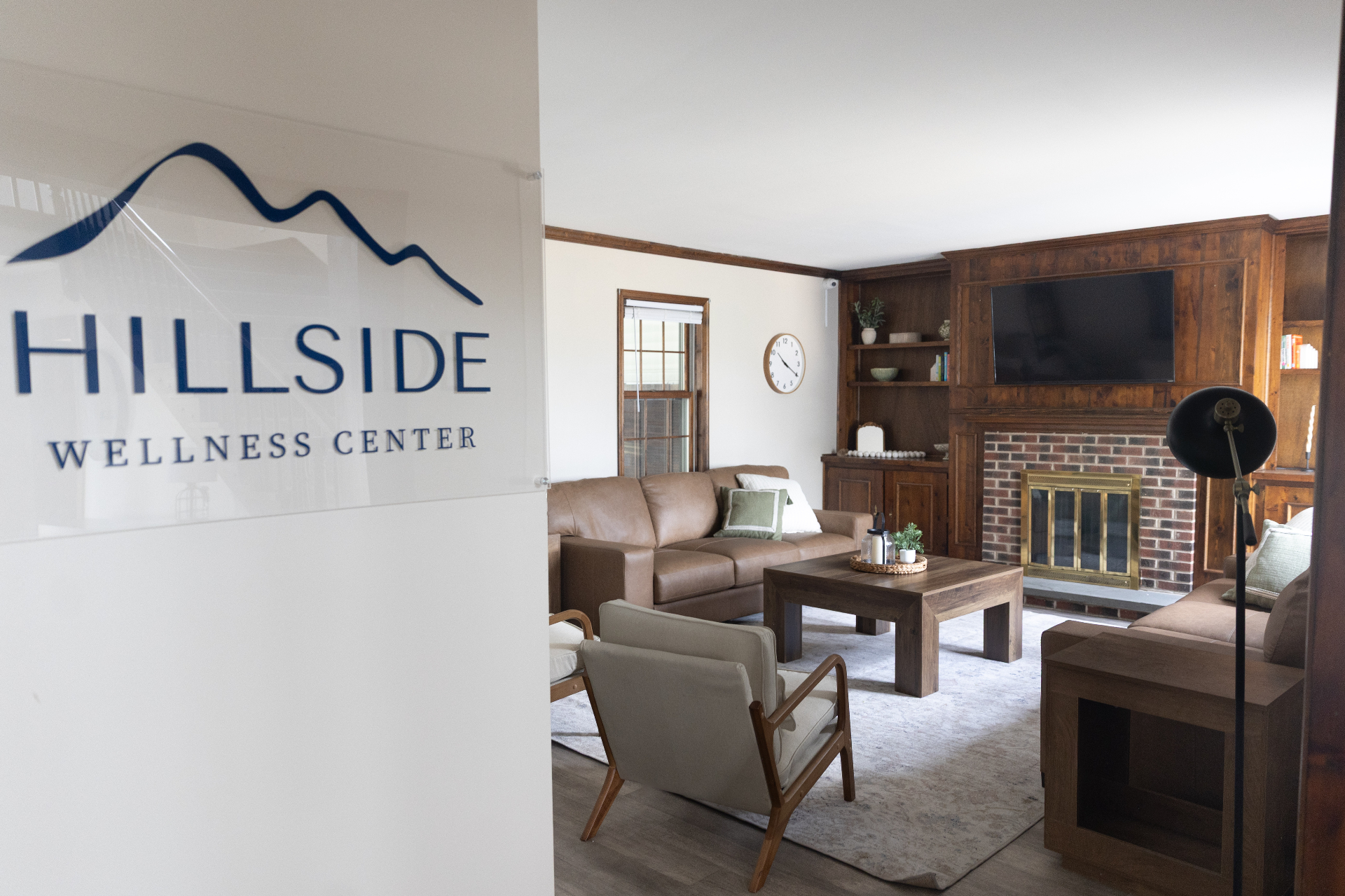 Wide view of the lobby with fireplace and signage