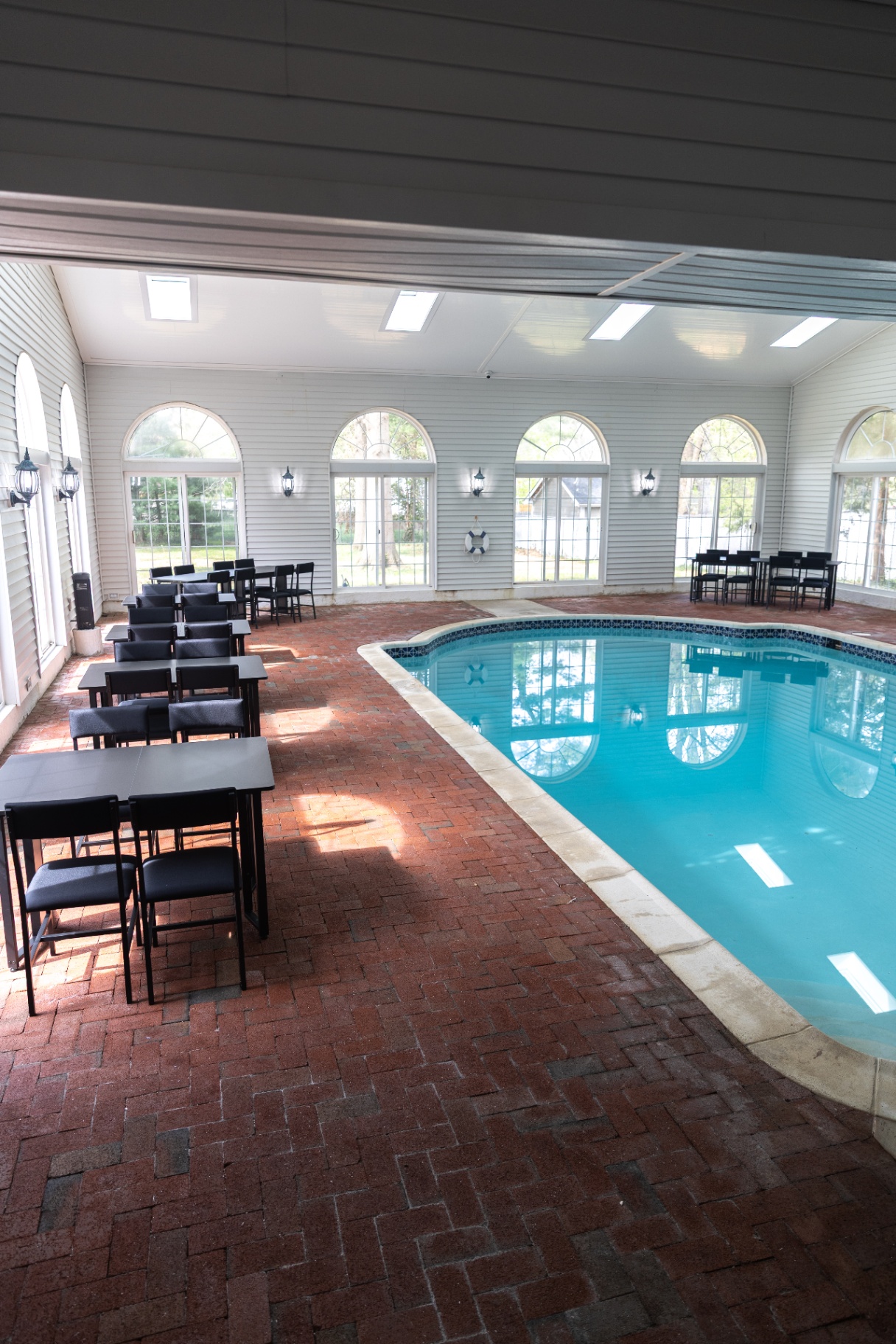 Indoor pool and dining tables alongside it