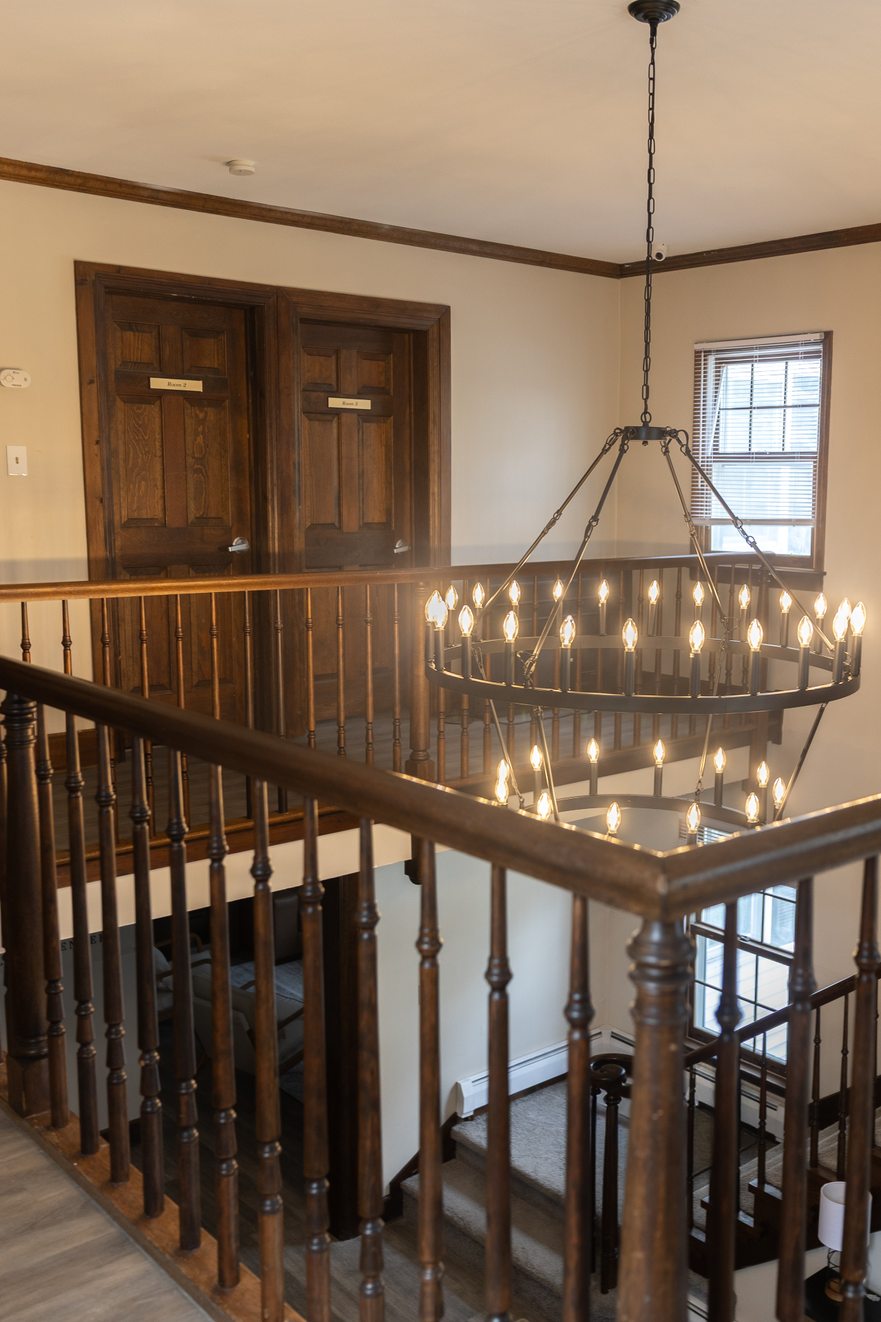 Upstairs rooms with chandelier in view